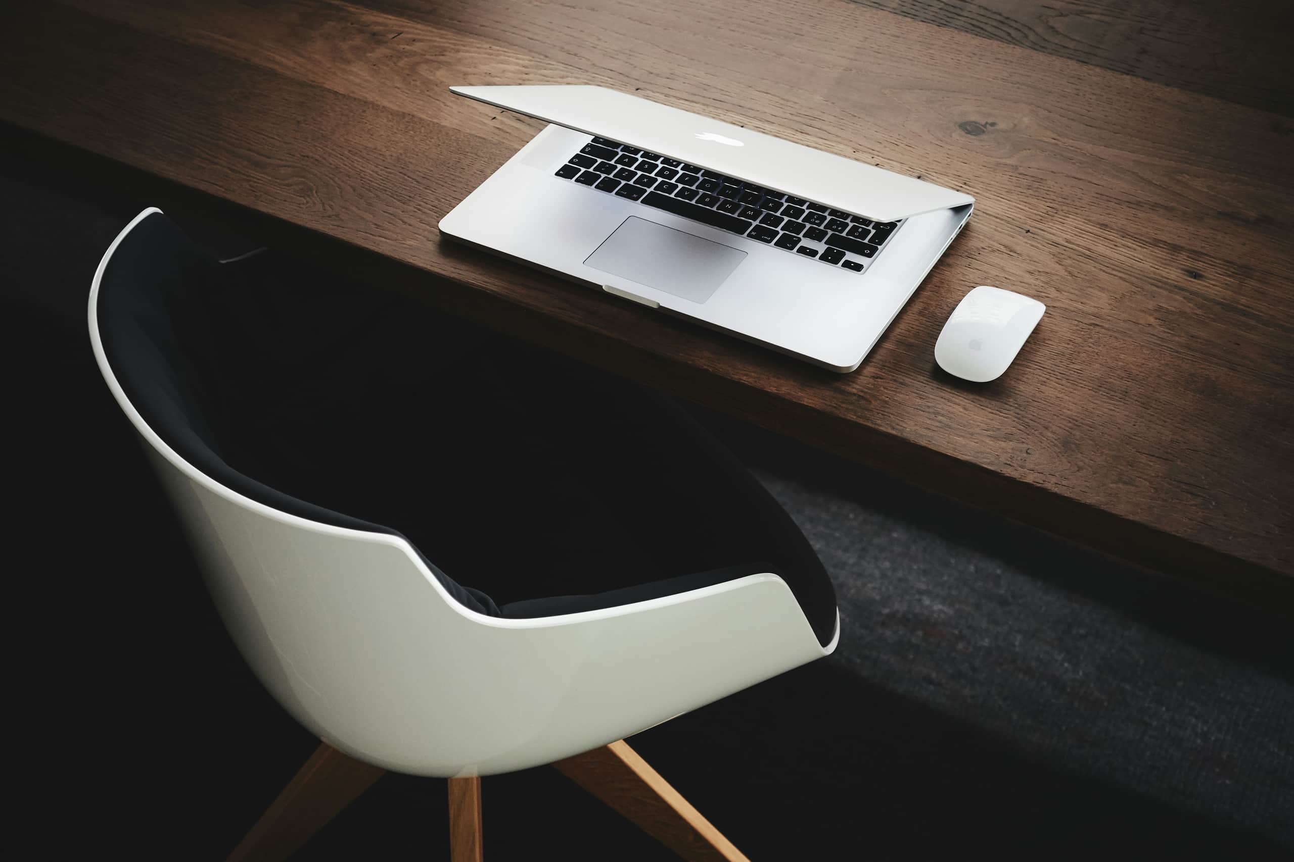 Person working at desk with laptop and phone.